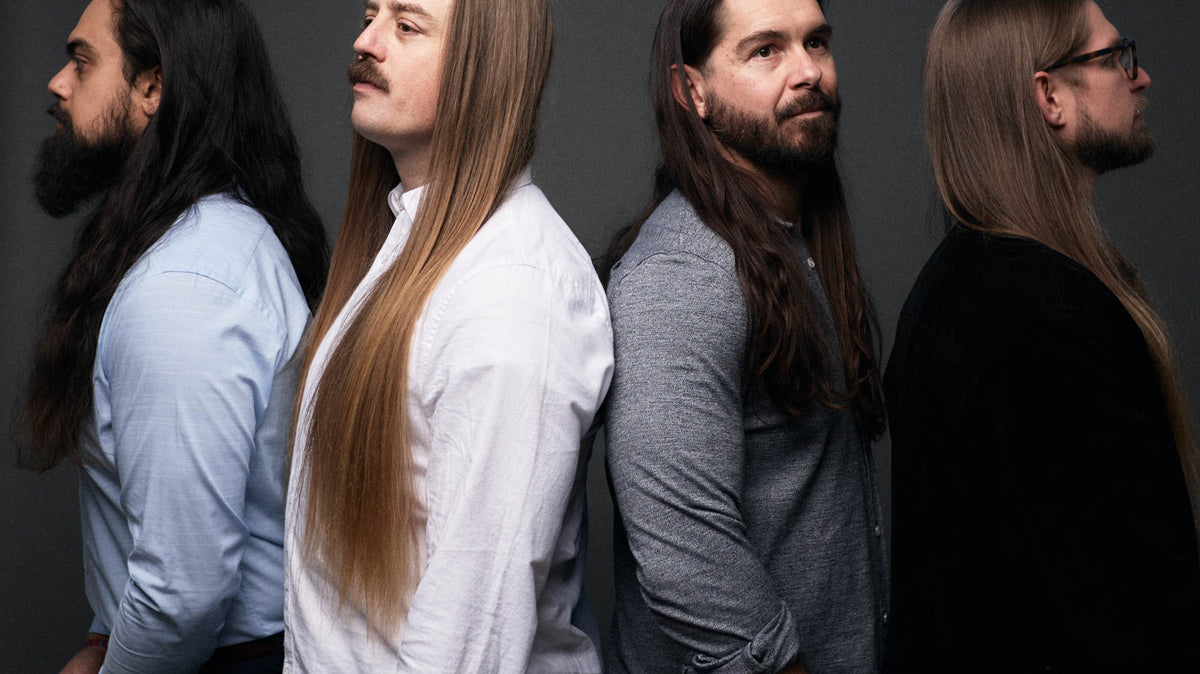 Jose Mejia and Chris Healy looking left, Lindsay Barto and Sean Horton looking right, standing in a line, in casual wear, in a studio, each looking off to the side. By Erica Joan 2024.