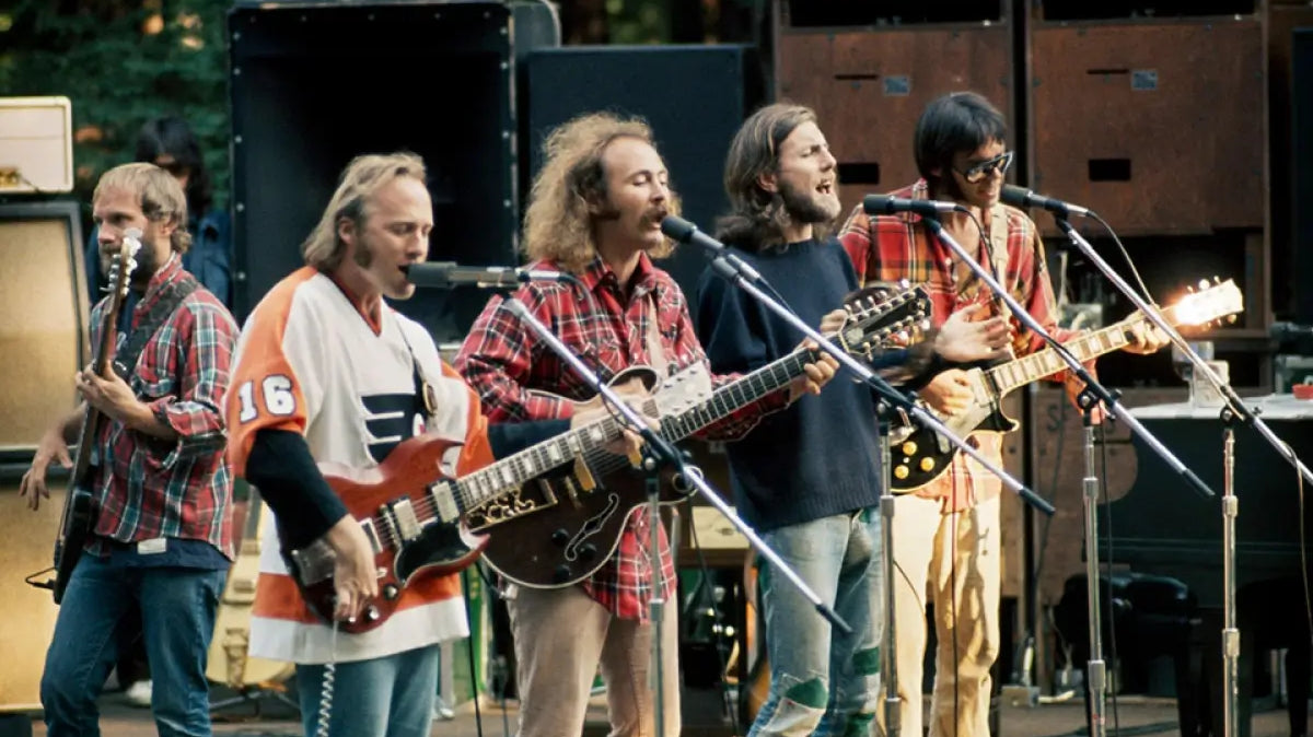 Crosby Stills Nash and Young playing on stage. Photo Credit: John Maginnis