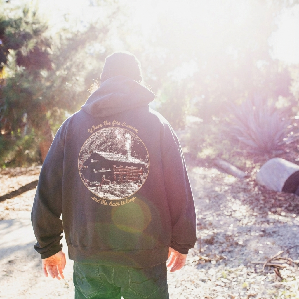 El Moreno wearing a hoodie with a nature-themed design outdoors
