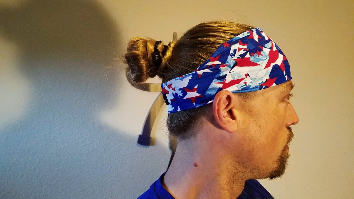 Two bros wearing headwraps and drinking beers at an outdoor bar in how to wear a headband long hair.