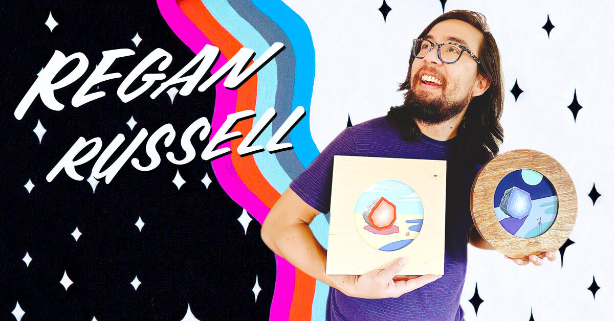 “I like to make artwork about pop culture and traversing the spaces between nostalgia and the unknown.” - Regan Russell holding his Portal pieces.