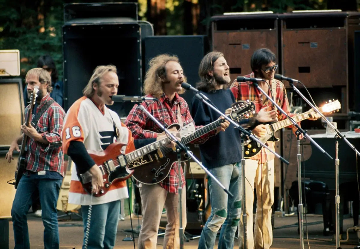 Crosby Stills Nash and Young playing on stage. Photo Credit: John Maginnis