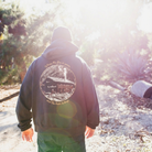 El Moreno wearing a hoodie with a nature-themed design outdoors