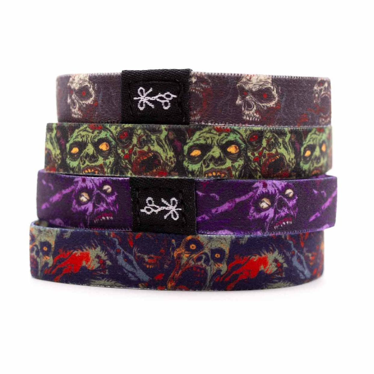 Three zombie and skull hair ties designs on a white background